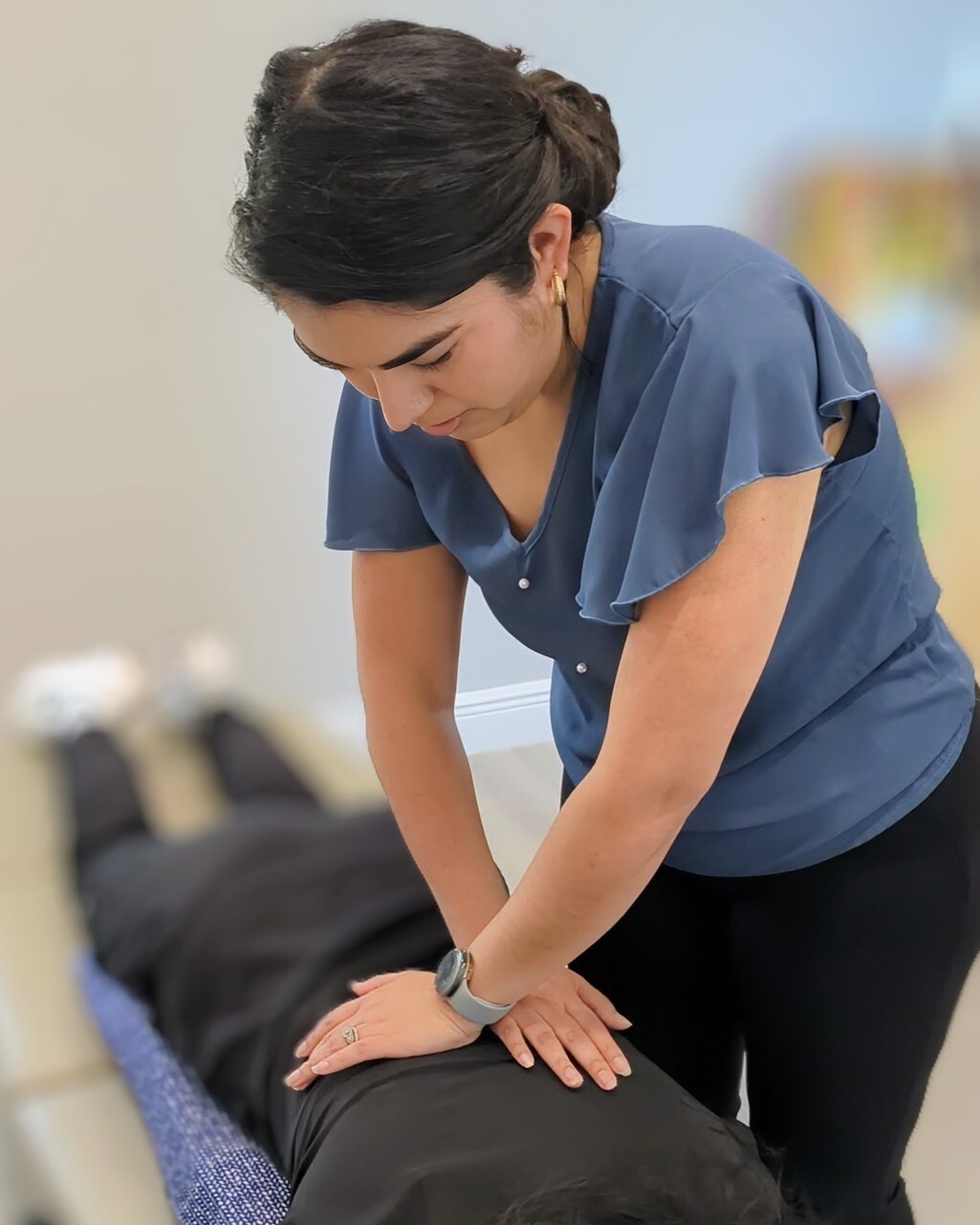Dr. Crystal Corona performing a gentle chiropractic adjustment